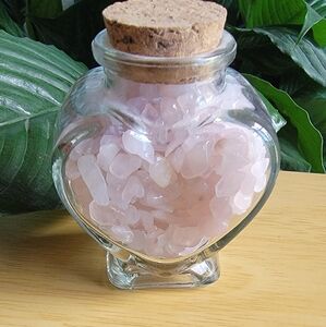 Heart-Shaped Glass Jar with Rose Quartz Chips.